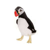 A Puffin Bird Stuffed Animal, artisan crafted and standing isolated on a white background, featuring a black and white body, colorful beak, and webbed yellow feet.