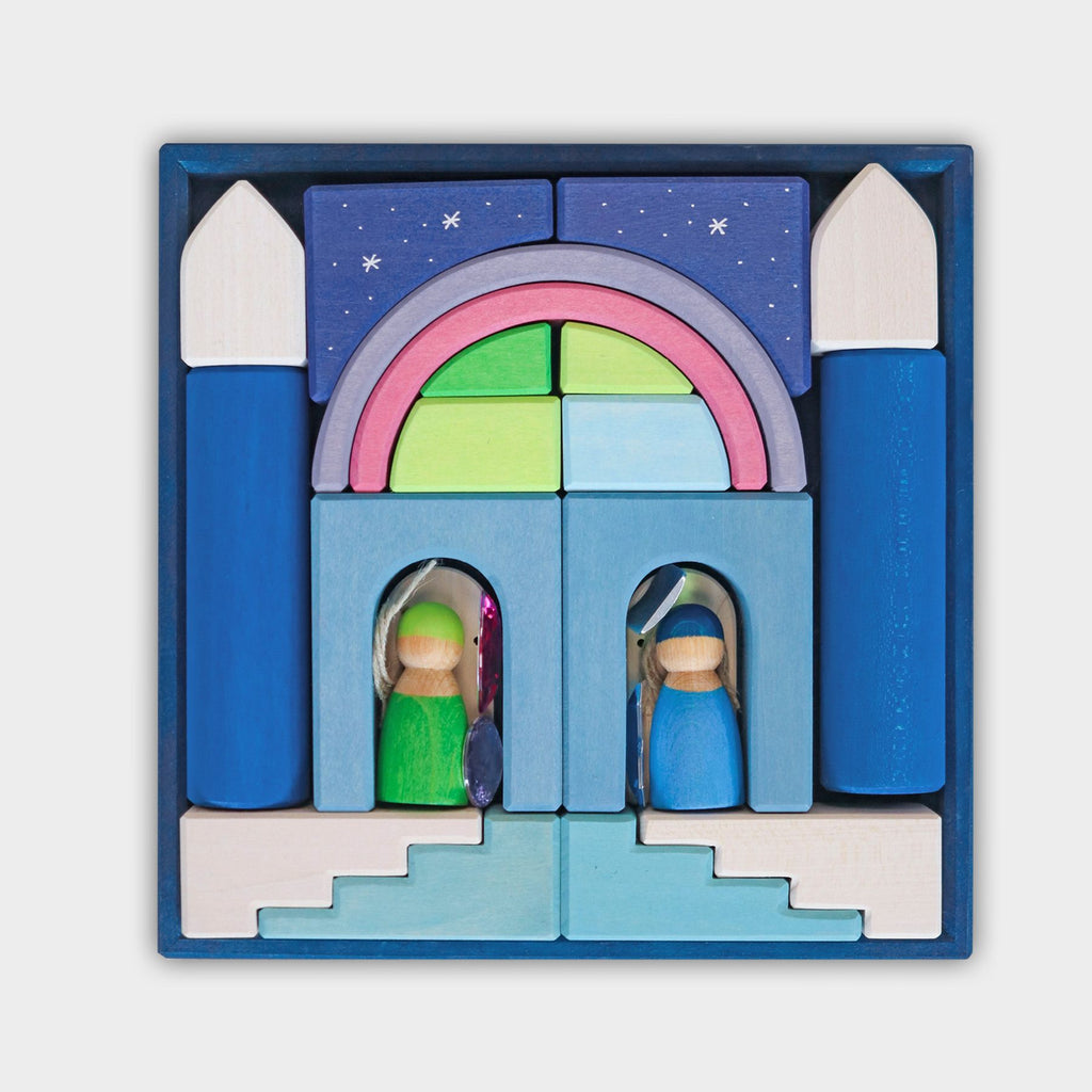 A set of wooden blocks arranged in a square, depicting a castle with two figurines in doorways. The blocks are in various colors, including blue, green, pink, and purple, and feature shapes like arches, towers, and stairs. Perfect for small Grimm's Building World Polar Light Block Set enthusiasts who love creative building materials.