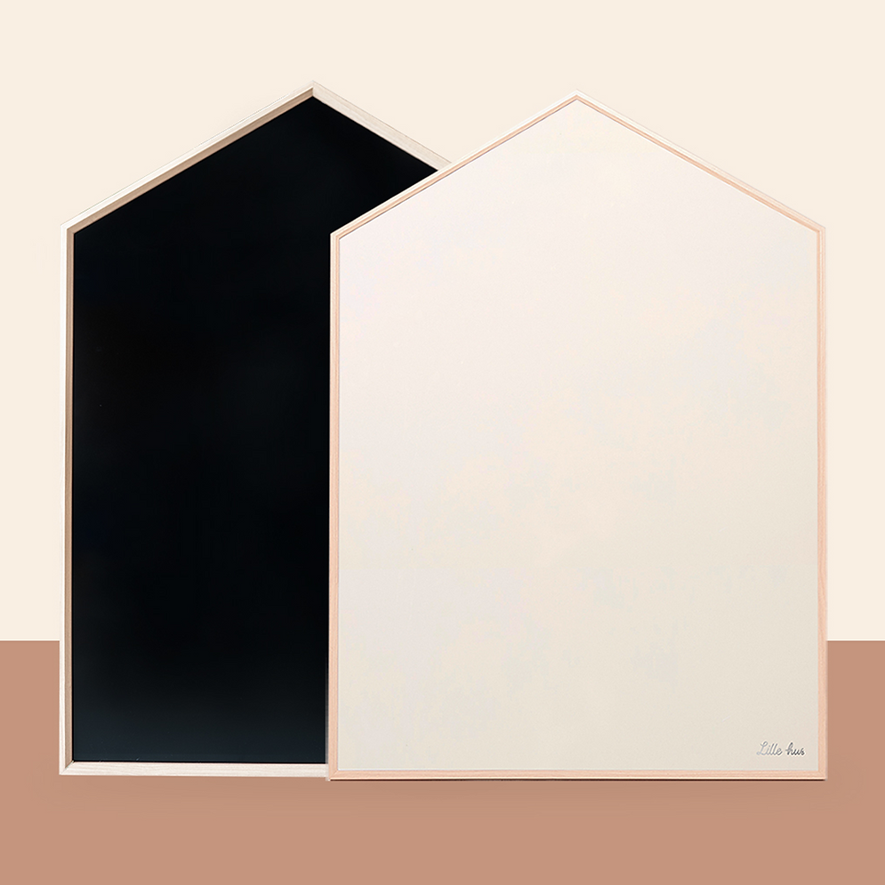 Two pentagon-shaped boards from the NORITER Signature Double-Sided Board Bundle stand side by side on a two-toned background. The board on the left is black, and the one on the right is white with a small logo in the corner. Both are framed with light wooden frames.