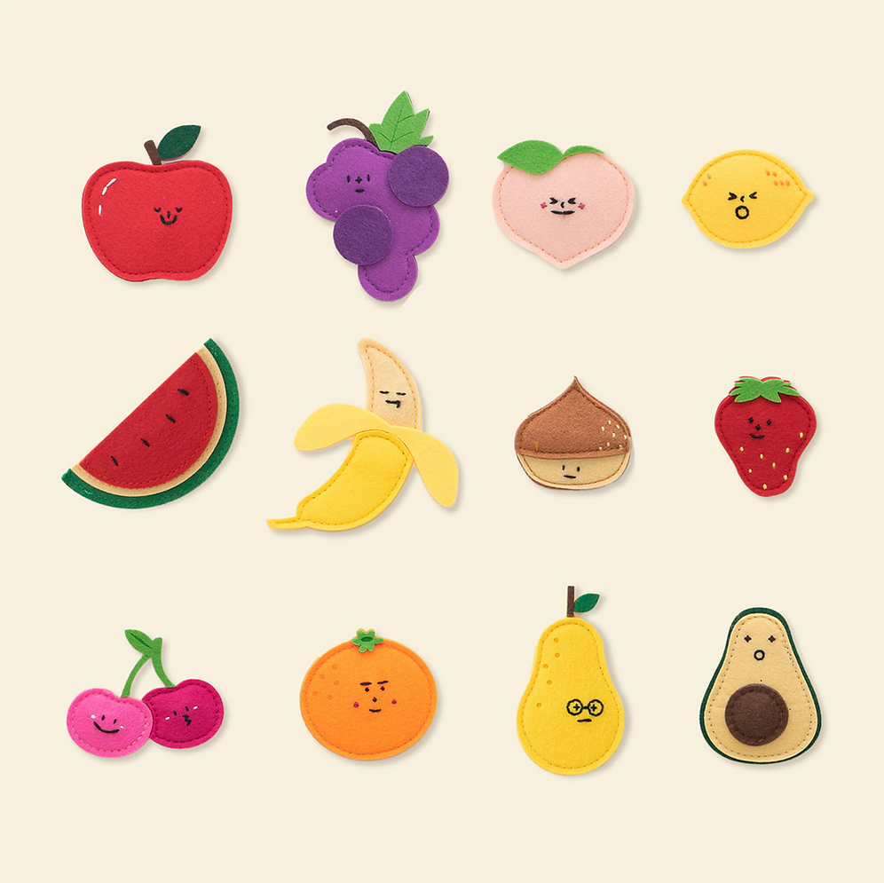 The NORITER Signature Double-Sided Board Bundle features a delightful assortment of felt fruit shapes with adorable faces, cheerfully displayed on an ivory board. It includes an apple, grapes, peach, lemon, watermelon, banana, chestnut, strawberry, cherries, orange, pear, and avocado.