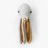 A BigStuffed Octopus - Pop-shaped wall decoration in white and yellow, featuring green button eyes. The yellow undersides of its long fluffy tentacles add a contrast to the white body, evoking a whimsical underwater world. The texture appears fluffy and woolly.