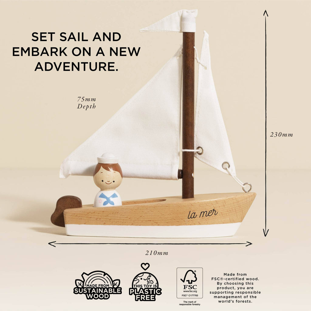 The Wooden Sailing Boat & Captain is a charming, handcrafted piece featuring a small sailing boat with a white sail and a sailor figure. The text reads, "Set sail and embark on a new adventure." The product comes with measurements, highlighting its construction from sustainable wood, free of plastic materials. It's ideal for enhancing cognitive skills development.