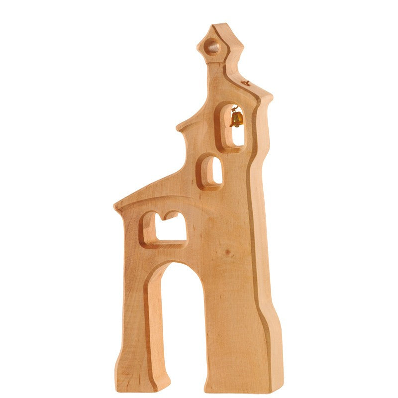 An Ostheimer Bell Tower resembling a tall, stylized church with several cutout windows and an arched doorway. There is a small, visible bell hanging in the top window. Made from light-colored, sustainably sourced wood with a smooth finish, it sparks imaginative play for all ages.