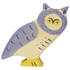 A wooden owl figurine painted in shades of purple and yellow, reminiscent of the Holztiger Owl. The owl has a detailed face with large yellow eyes and a beak, and intricate patterns on its body and wings, giving it a whimsical and stylized appearance.