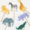 Meri Meri Jungle Animal Candles on sticks, including a lion, zebra, giraffe, elephant, rhinoceros, and crocodile, arranged on a light background for a jungle party.