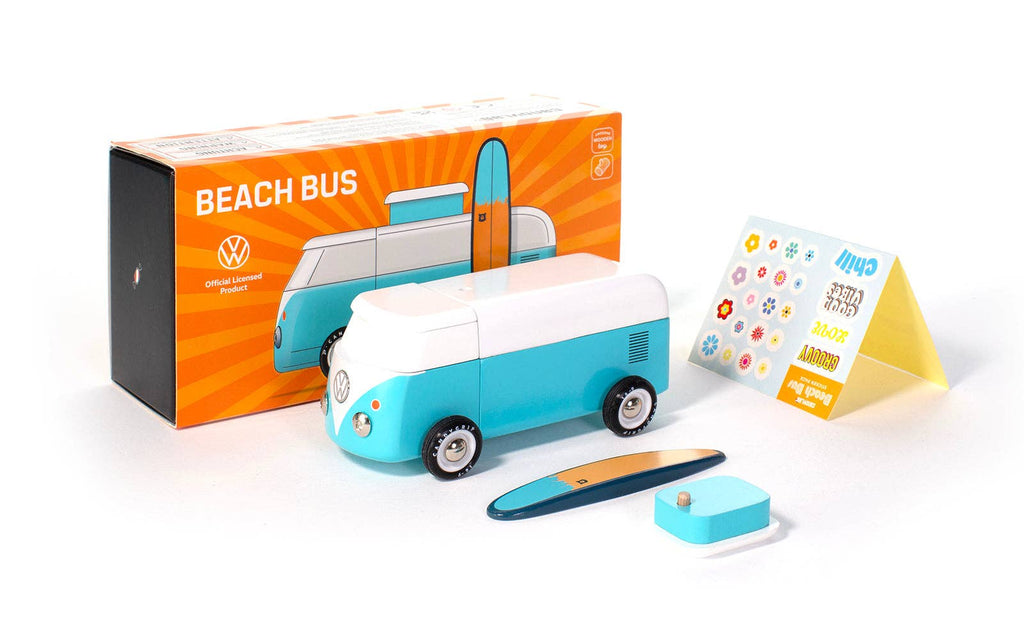 A VW Beach Bus Ocean toy, styled as a blue and white Volkswagen Type 2 with a surfboard on top, is showcased next to its colorful packaging. Included in the package are small stickers and an instruction card. The box features vibrant orange graphics with the words "Beach Bus" and includes a magnetic camper top for added fun.