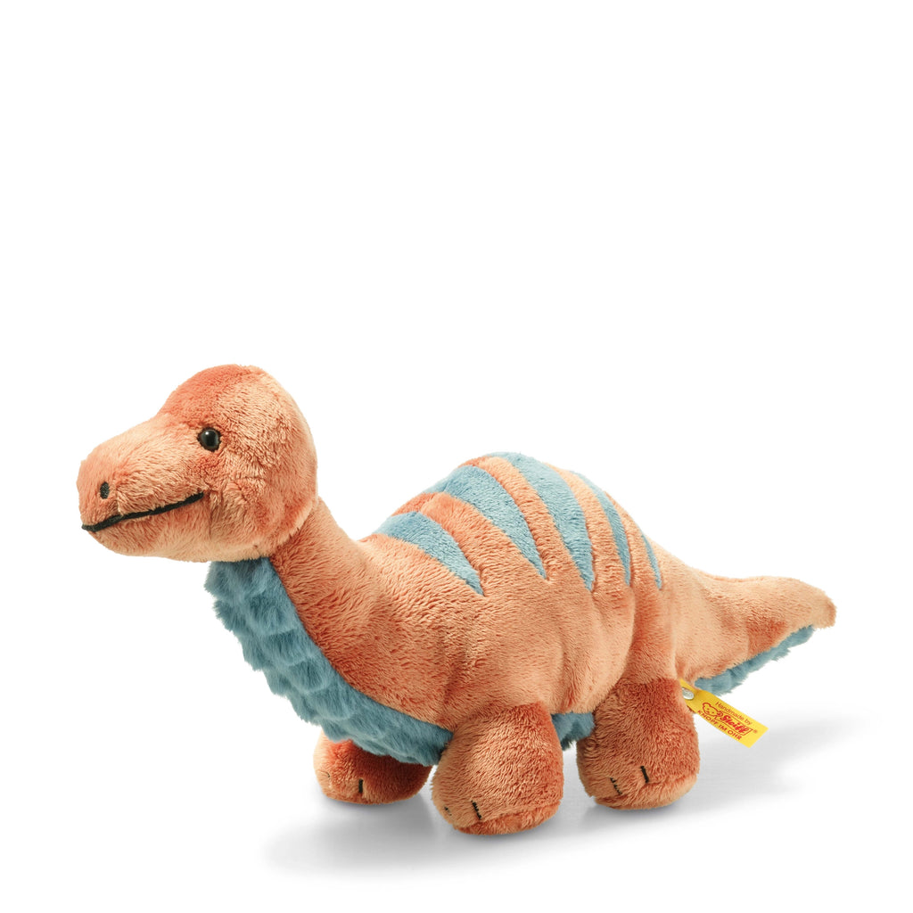 A soft Steiff, Bronko Brontosaurus Dinosaur Plush Stuffed Toy, 11 Inches shaped like a dinosaur with a light brown body and blue stripes on its back. The dinosaur has a cheerful expression with black bead-like eyes and a small smiling mouth. The stuffed toy has four short legs and a long neck, perfect for dino lovers.