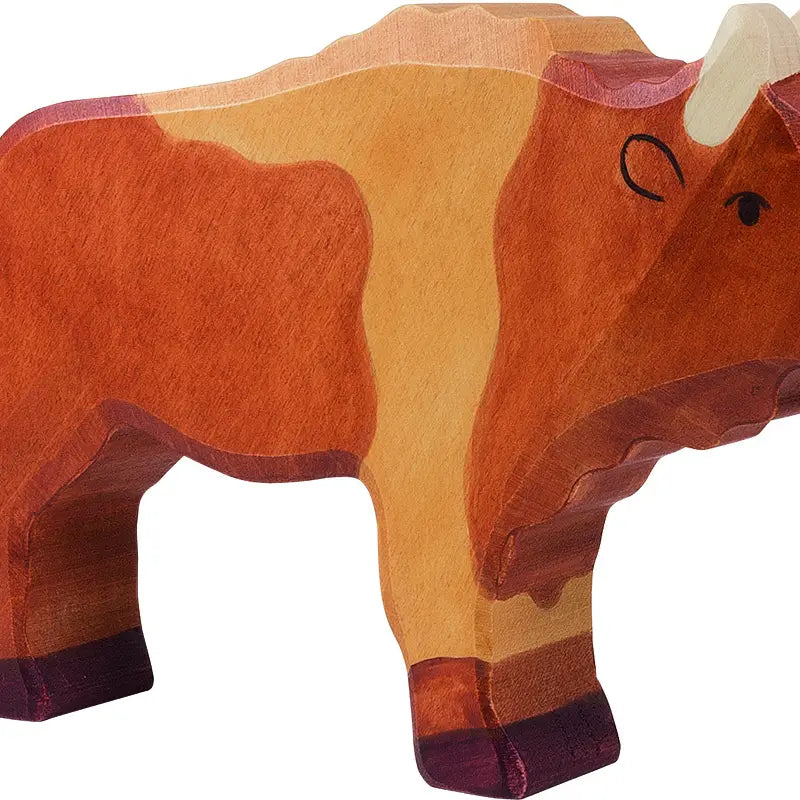 A wooden toy figure of a bison, painted with shades of brown and orange, stands on four legs. The toy has a minimalist design with painted eye and horn details. Crafted from handcrafted wood by Holztiger Bison, it showcases the finest European craftsmanship.
