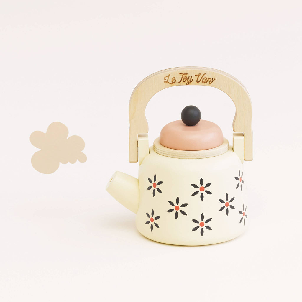 The Vintage Wooden Role Play Kettle is a delightful toy teapot featuring an eco-friendly, FSC certified wooden handle and a pink lid, beautifully decorated with black and orange flowers. A small cloud shape adds to its appeal against a plain white background.