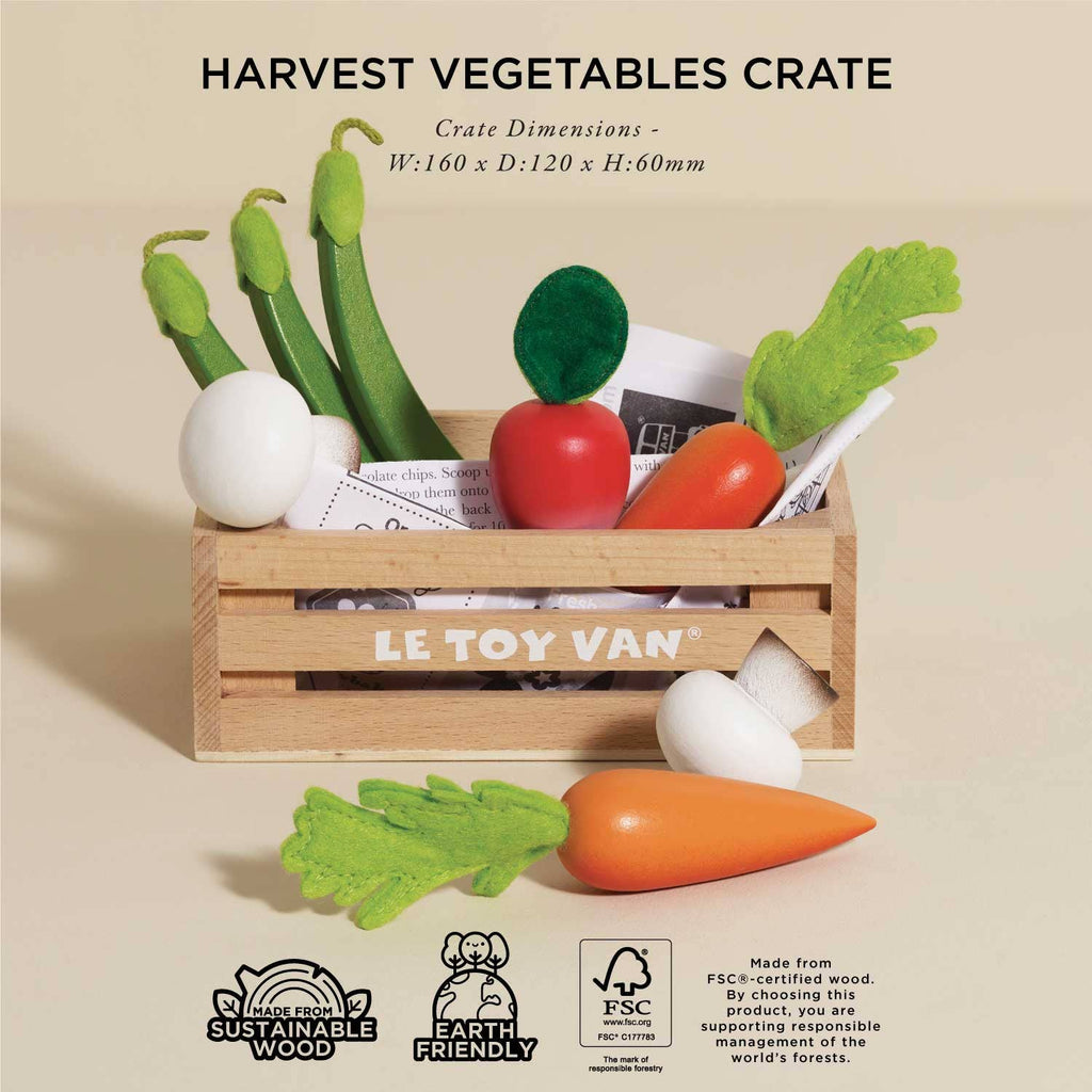 A "Harvest Vegetables Wooden Market Crate" by LE TOY VAN, packed with vibrant felt veggies like carrots, radish, and peas, showcases sustainable materials. Labels note earth-friendly credentials and crate dimensions are noted above.