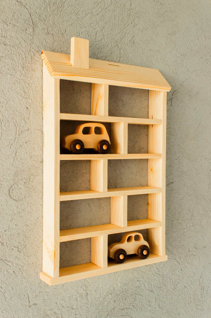 A charming Wooden Shelf No. 22 with toy cars neatly arranged on it, perfect for a children's room.