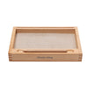 A Montessori Tray labeled "Sand Tray with Flash-Card Holder" is shown. It contains fine sand and includes a wooden stylus resting at the front of the tray, perfect for honing writing skills. The tray features clean, simple lines and a natural wood finish, making it an ideal educational toy.