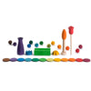 An assortment of sustainable colorful wooden toy pieces, including spheres, cylinders, and blocks from Grapat Your Day, arranged in a neat row on a white background.