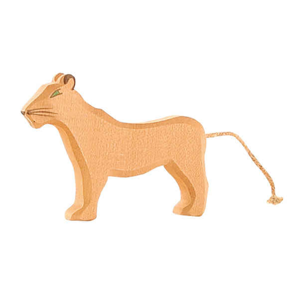 A wooden Ostheimer Female Lion stands on all fours. The handcrafted figure has minimalistic features, including a simple face with painted details and a thin rope tail. Made from light-colored, smooth wood, this piece showcases Ostheimer toys' commitment to using sustainably sourced materials.