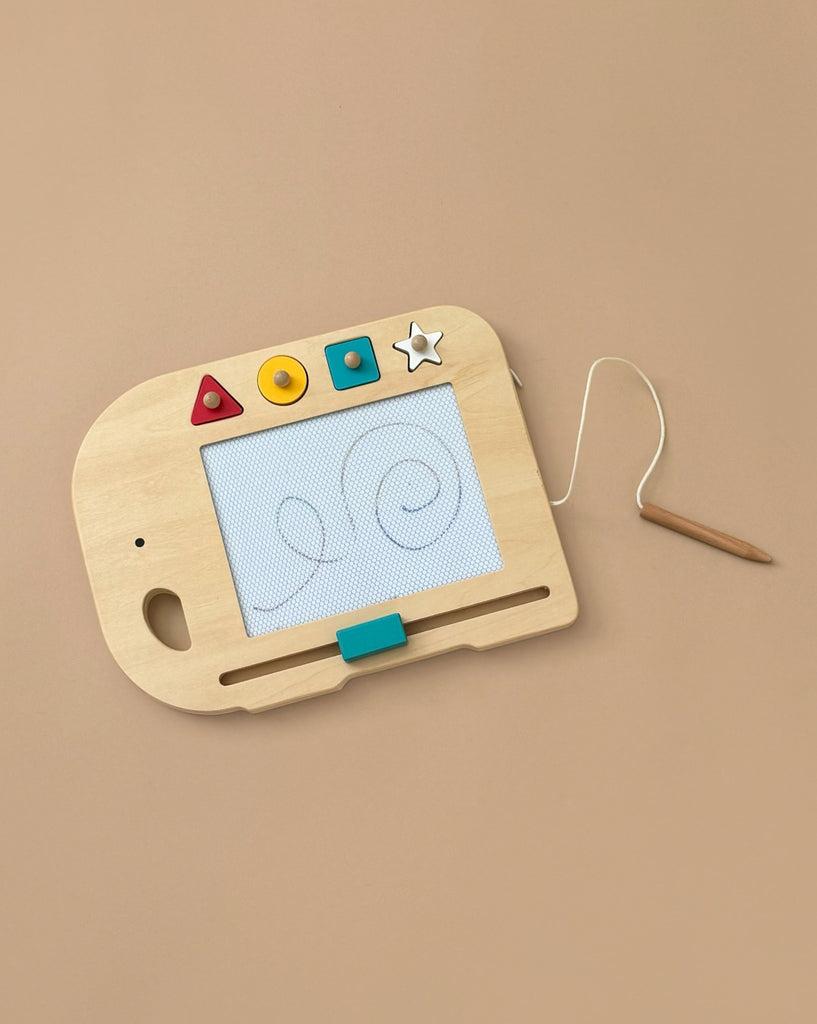 The Wooden Elephant Magic Drawing Board is a creative toy for children, featuring colorful geometric buttons along with a scribble pad and magnetic pen attached by a string. It is displayed on a beige background.