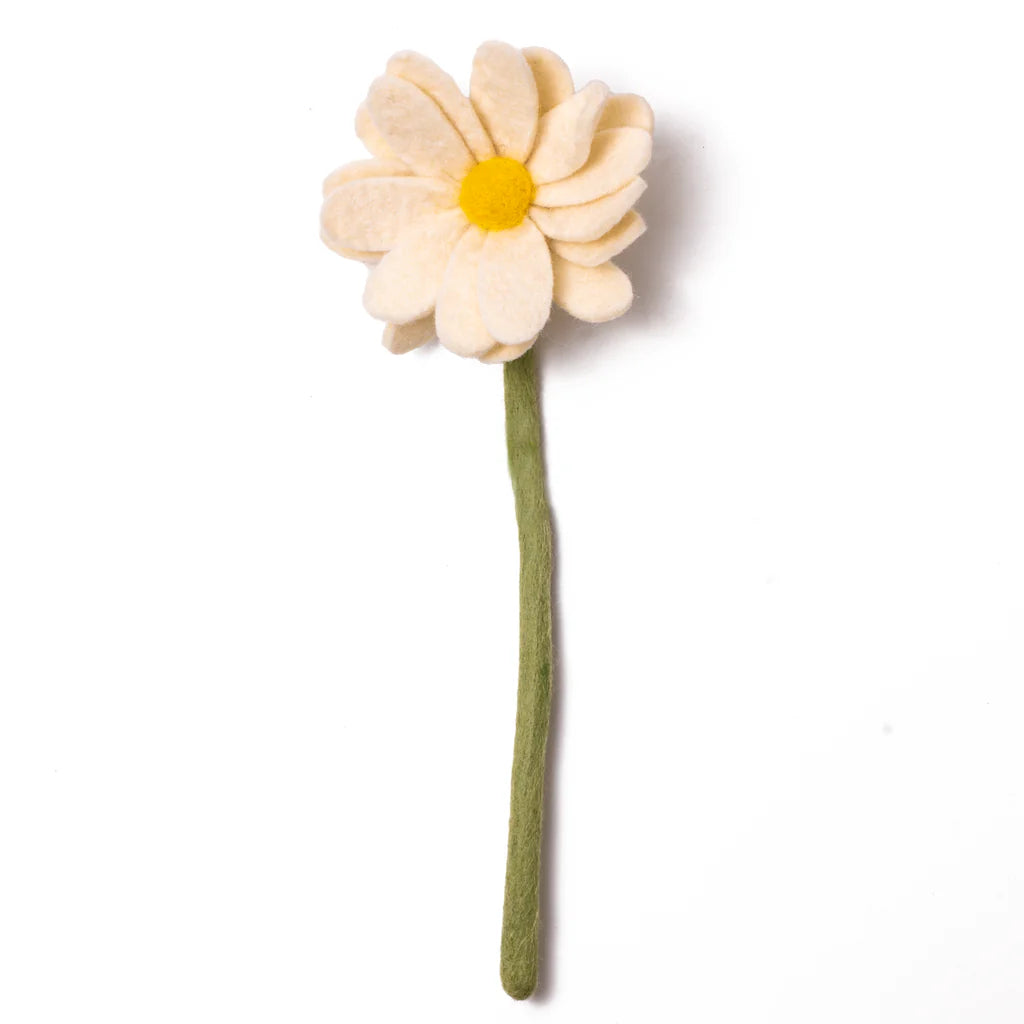 The "Basket of Felt Flowers" includes a charming felt daisy featuring layered cream-colored petals and a yellow center on a green stem, all handcrafted with eco-friendly materials. The background showcases the product against a plain white backdrop.