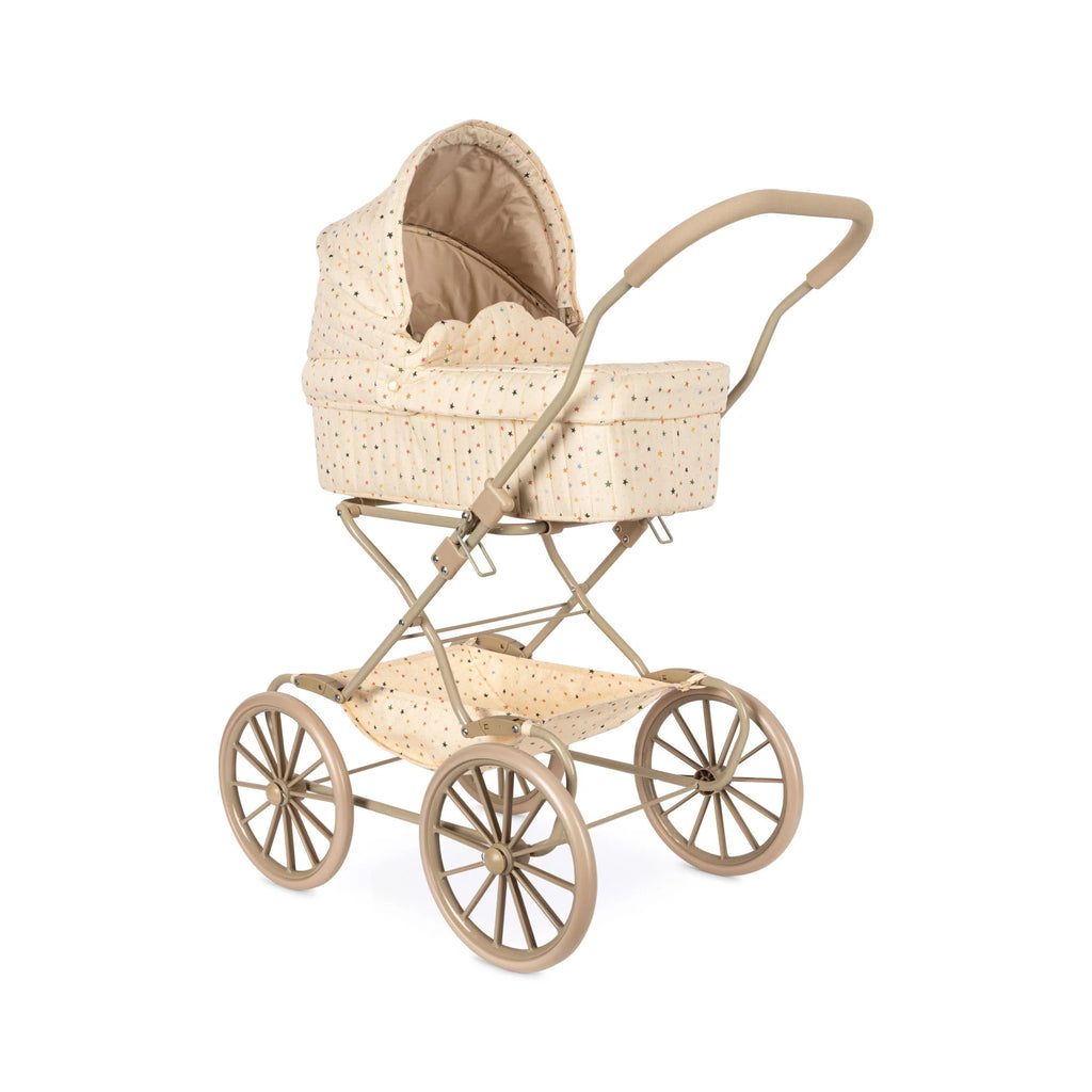 Introducing the Doll Pram - Multi Star: This charming vintage-style stroller features a classic beige design adorned with multi-colored stars. It boasts four large spoked wheels and a gracefully curved handle. The pram offers a comfortable covered seat perfect for infants, complete with an undercarriage storage basket, all carefully crafted from recycled materials.