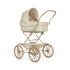 The Doll Pram - Fleur Coloré is a vintage-style baby stroller that evokes the charm of a classic doll pram. It showcases a beige floral-patterned canopy and fabric, crafted from recycled materials. With its four large spoked wheels and tan handle, it combines elegance with eco-consciousness.