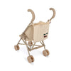 A beige **Konges Sløjd Doll Stroller - Glitter Cherry** with cushioned handles, double wheels, and a padded backrest that features a simple cherry design. The stroller appears compact and lightweight, designed for easy maneuverability and portability.