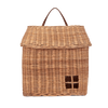 The Olli Ella Hanging Rattan Basket Hutch is a woven wicker basket designed to resemble a small house, complete with a pitched roof and a handle at the top. This handcrafted rattan storage solution features a charming square window detail on the front.