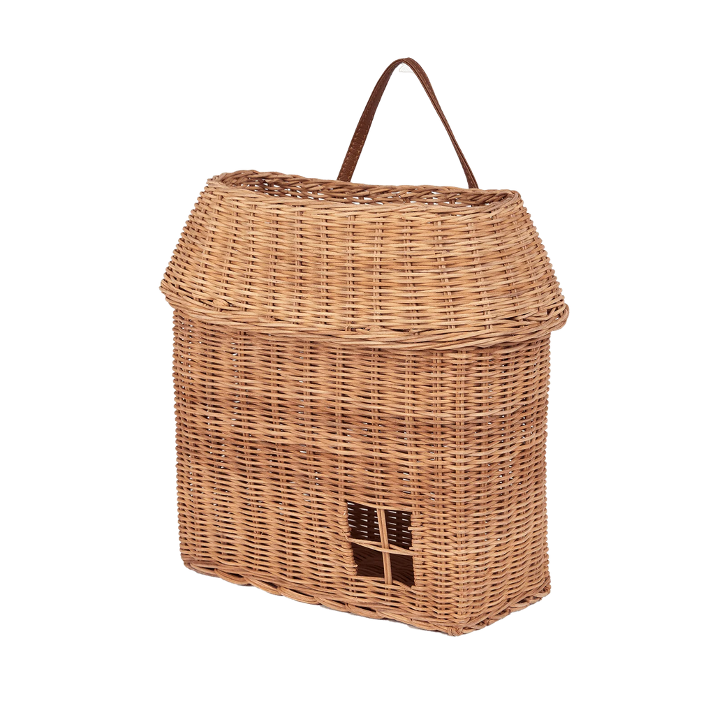 The Olli Ella Hanging Rattan Basket Hutch is a wicker picnic basket crafted to look like a house, complete with a roof-shaped top and a charming small window detail on the front. This handcrafted rattan storage piece also features an easy-to-carry handle.