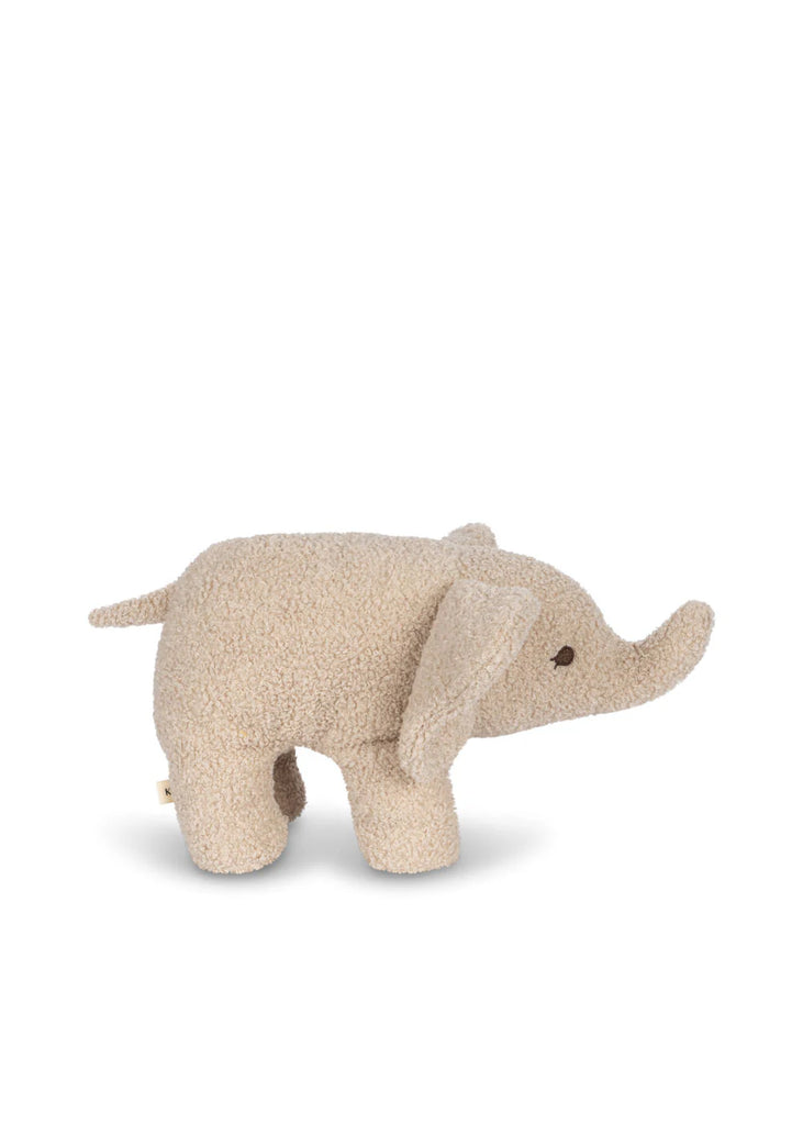 The Elephant Teddy Stuffed Animal is a small, snuggly toy made from beige, textured fabric. This plush toy features large, floppy ears, a short tail, and an elongated trunk. Its eyes are stitched brown dots that give it a simple and cute appearance. The background is plain white.