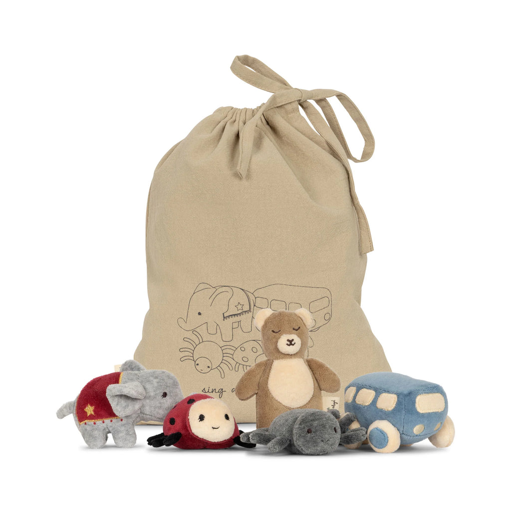 A Konges Slojd | Five Piece Rattle Activity Set with illustrations of animals and vehicles is surrounded by five velour toys: a grey elephant wearing a red outfit, a ladybug, a brown bear, a blue car, and a grey mouse.