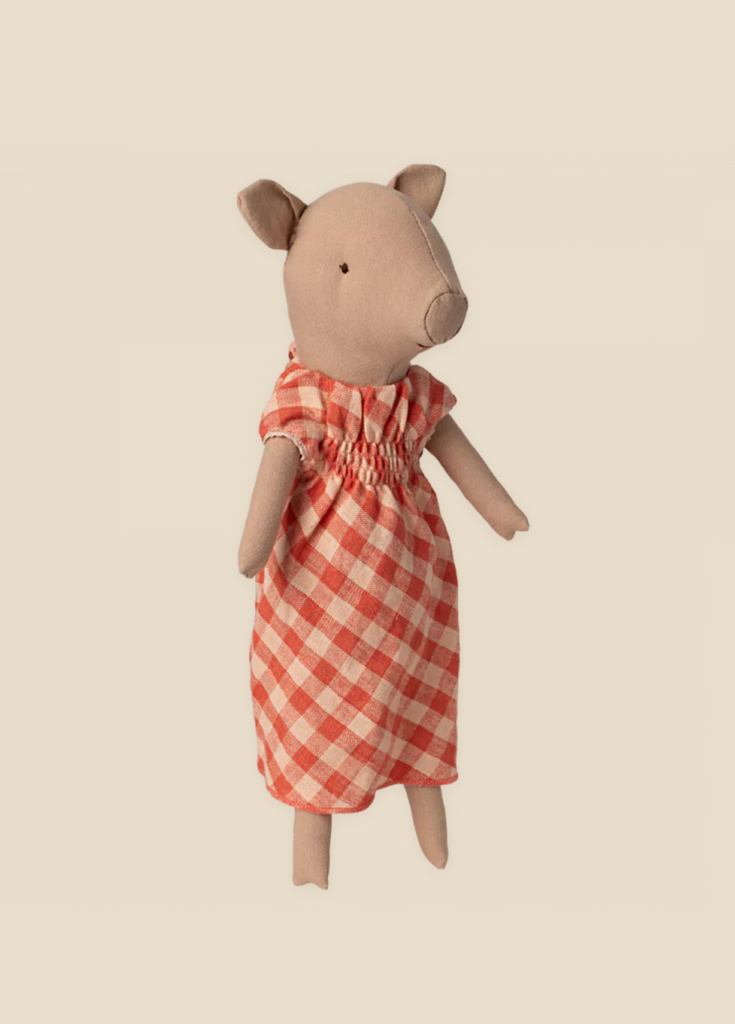 A Maileg Pig In A Dress, centered against a plain light beige background. The adorable pig has a simplistic design with visible stitching and a gentle expression.