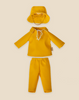 The Maileg Extra Clothing: Rainwear for Teddy Dad, consisting of a yellow wide-brimmed hat, a long-sleeve shirt with a drawstring neck, and pants, is showcased against a beige background.