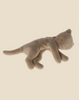 A Maileg Plush Kitten, Cream peach (ships in approximately one week) designed to resemble a sleeping cat. The toy is light brown in color, with a long tail and closed eyes. It is lying on its side in a cosy basket, creating a relaxed and peaceful appearance. Perfect for any pet collection.