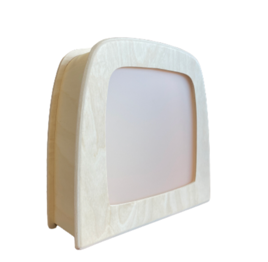 A minimalist light wood frame encases a frosted rectangular panel, resembling a small screen or display. The design features smooth, curved edges and a clean, modern aesthetic. Enhanced with warm LED light, the Toverlux Magic Lamp adds an inviting glow to any room. The background is plain white.