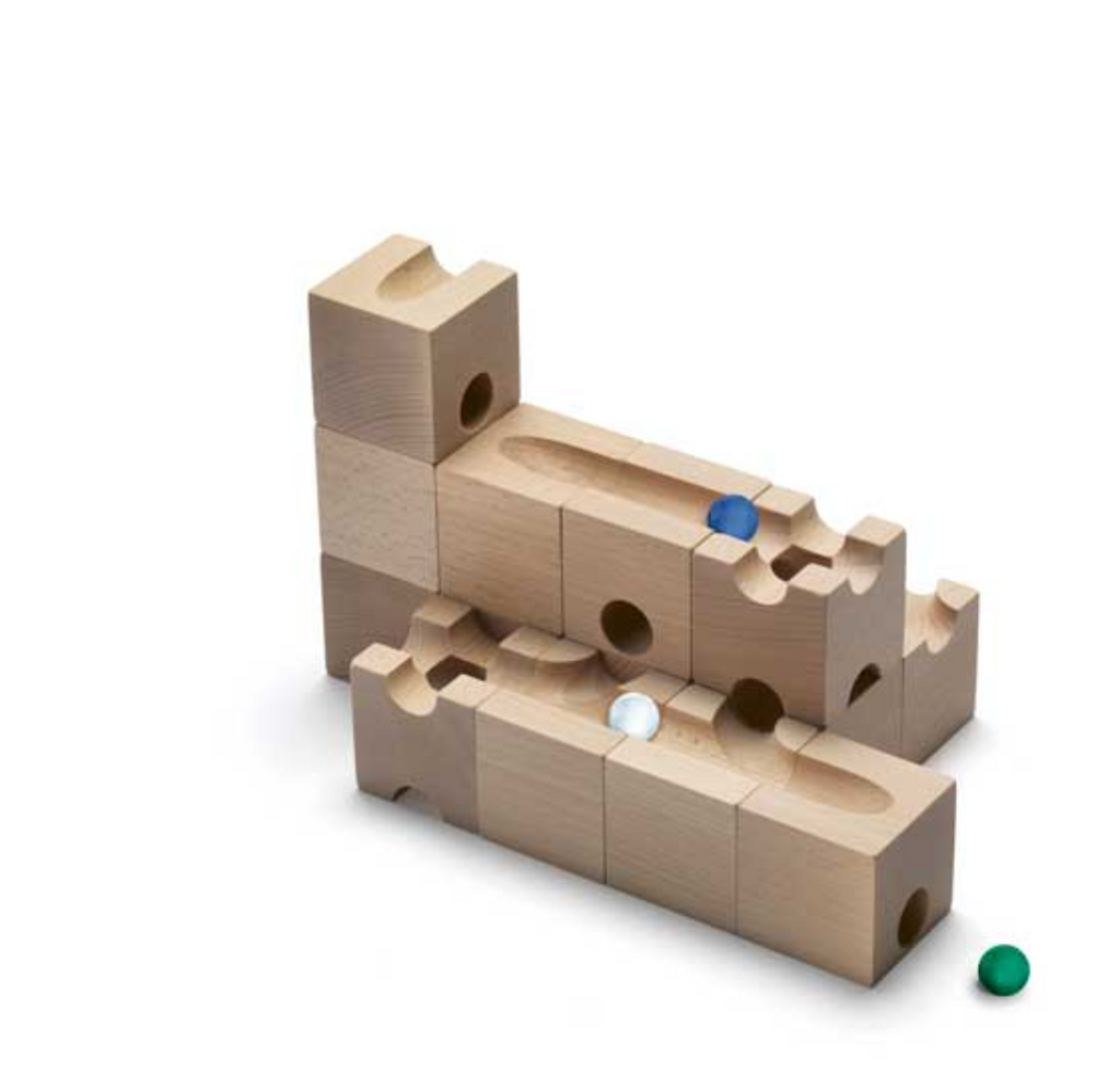 The Cuboro Trick Marble Run Extra Set is a three-dimensional marble run system composed of cuboid and rectangular wooden blocks featuring grooves and holes for marbles. The visible marble colors include blue, white, and green. Designed to enhance fine motor skills, this set allows marbles to travel through the intricately arranged grooves, fostering spatial imagination.