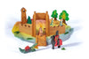 The Ostheimer Daughter of the Castle playset features a vibrant wooden castle with a drawbridge, a knight on horseback, a dragon, and numerous trees and characters. This handcrafted toy set is laid out on a pastel-colored cloth mat, creating an imaginative scene for delightful play.