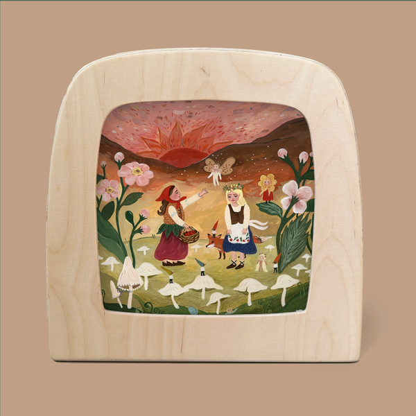 An enchanting scene featuring the "Fairy Sunset Silhouette for Toverlux Lamp," showcasing a playful illustration of two children outlined against a magical fairy sunset, enveloped by mushrooms and flowers. A large sun descends in the background, radiating a warm glow through translucent materials, all beautifully framed within a wooden arch.