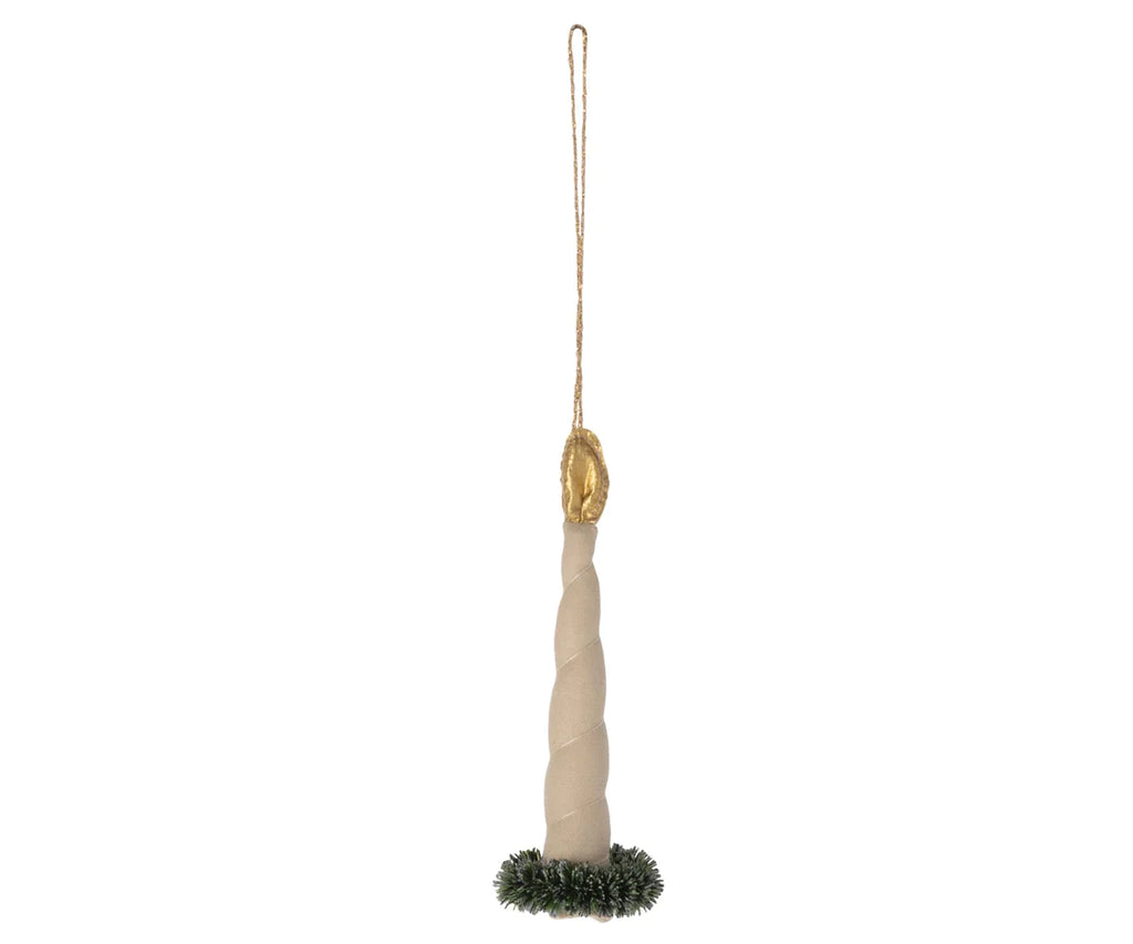 The Maileg Ornament - Candle Light features a twisted beige candle with a gold flame and a hanging string, bringing an exclusive look to your decor. Its base is adorned with a small green wreath, reminiscent of Maileg Christmas tree ornaments, adding charm and elegance to any festive setting.