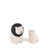 Two ceramic figurines resembling a lion and a lion cub. The lion has a black mane and stands taller, while the cub is smaller and lacks a mane. Both cream-colored pieces showcase minimalist features and face each other, reminiscent of Handmade Tiny Wooden Animals - Lion Family Set of 2 in their simplicity.