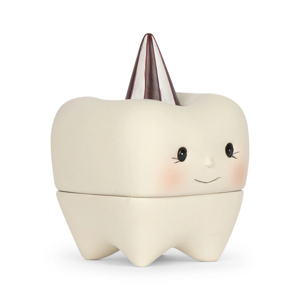 A cute, tooth-shaped Konges Sløjd Stone Tooth Box with a smiling face and blushing cheeks. The box is white stone with a glossy cone-shaped lid that resembles a shiny silver tooth cap, perfect for holding your child's first teeth.