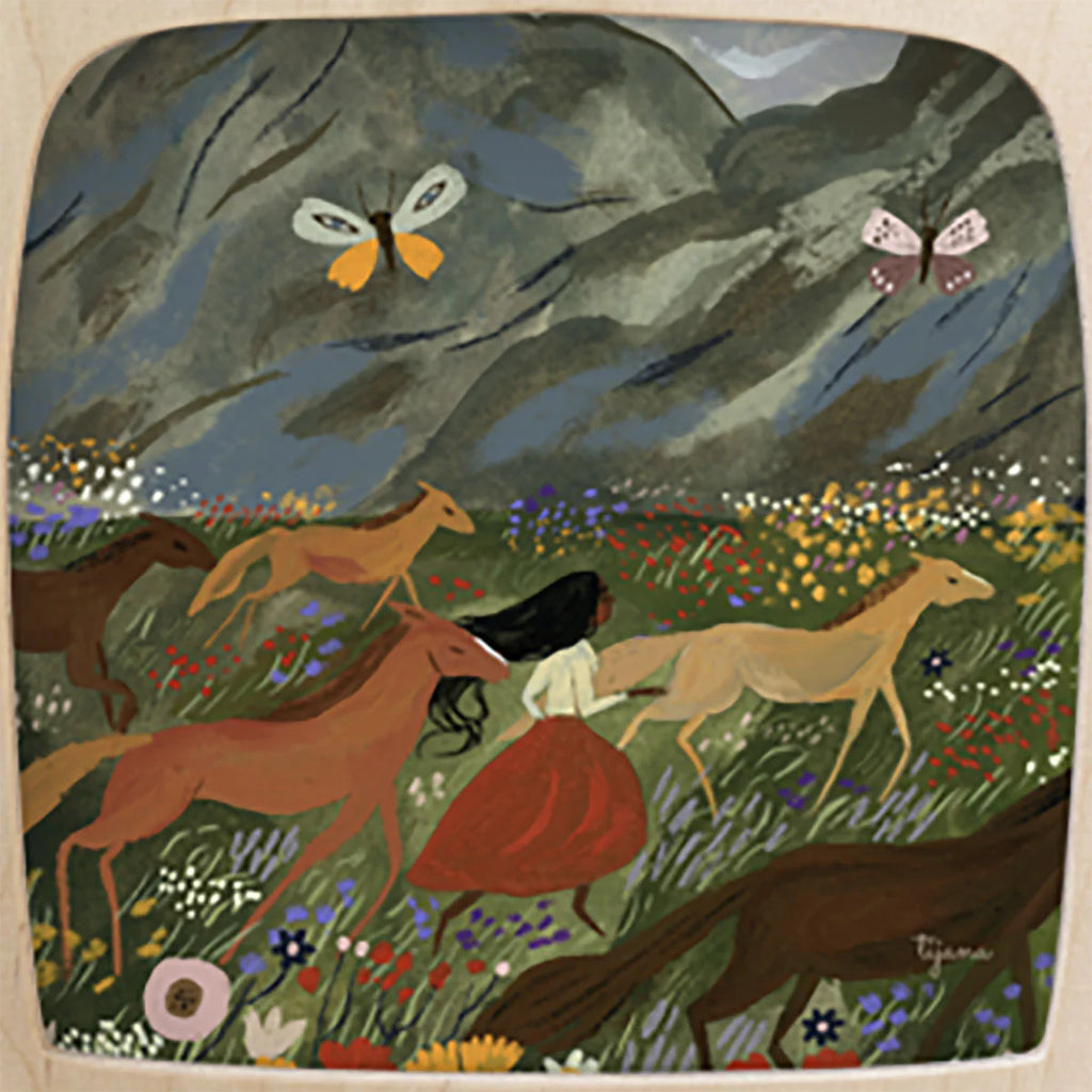 A woman donning a vibrant red skirt dashes through a colorful meadow, seamlessly blending into the landscape with her Magic Silhouette from the Wild Spring collection. Nearby horses gallop gracefully while two butterflies flit above. This picturesque scene is set against rolling hills adorned with wildflowers beneath a cloudy sky.