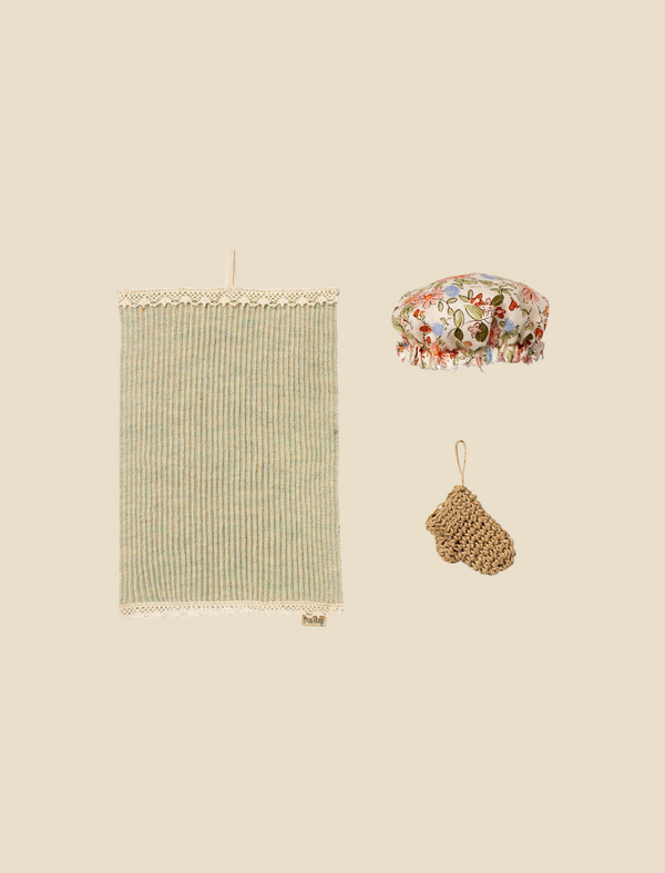 A flat lay of a Maileg Wellness Set on a pale yellow background.