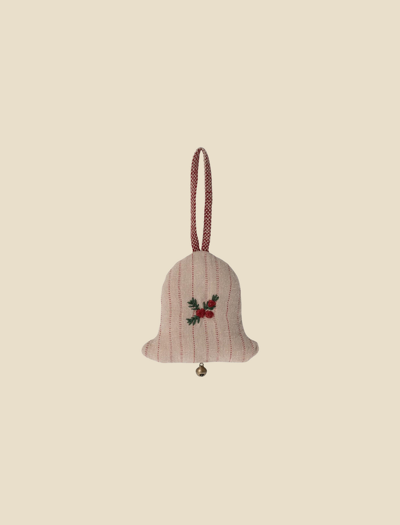 The Maileg Ornament - Small Bell is a beige fabric ornament shaped like a bell, adorned with red vertical stripes and a small sprig of holly at the center. Crafted from exclusive fabrics, it features a red loop for hanging and includes a small jingle bell at the bottom. This exquisite piece is an elegant addition to any Christmas ornament collection against a light beige background.