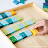 The "Grimm's Counting with Colors" preschool arithmetic set features a wooden frame with blocks numbered from 1 to 110. The mainly green blocks are accented by vibrant numbered snakes in colors like purple, representing higher numbers such as 200, 300, and beyond. Arithmetic symbols are displayed below the numbers for easy learning.