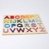 Introducing Grimm's ABC Game: A sturdy wooden puzzle board featuring colorful, three-dimensional letters crafted from non-toxic materials. The vibrant red, orange, yellow, green, blue, and purple letters are neatly arranged in rows within the robust wooden frame.