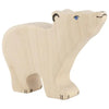 A handcrafted wooden toy shaped like a polar bear, standing on all four legs. The bear is light in color with simple black facial features, a blue eye, and minimal detailing, giving it an abstract and playful appearance akin to Holztiger Polar Bear, Small, Head Raised.