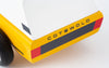 Close-up of the Candylab Cotswold toy vehicle's rear end, showcasing a white top, yellow body, black wheels, and red taillights. The black text "COTSWOLD" is prominently displayed on the yellow part of the car's back. Perfect for comfortable travel adventures in miniature form.