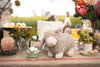 Charlotte the Sheep Stuffed Animal rests comfortably on the table, awaiting her flock-mates.