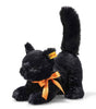 A plush black cat with green eyes is wearing an orange bow around its neck. The Spooky Black Cat Plush Toy Halloween is in a playful, crouching position with its tail raised, perfect for adding a touch of cuddly softness to your Halloween decor.