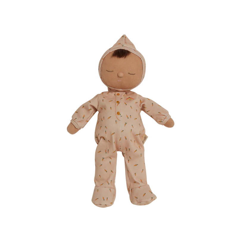 Plush doll with a stitched smile and closed eyes, wearing a beige onesie crafted from 100% organic cotton with a pattern of small, colorful triangles. The Olli Ella x Odin Parker Dozy Dinkum - Bugsy Hopscotch stands unaided against a