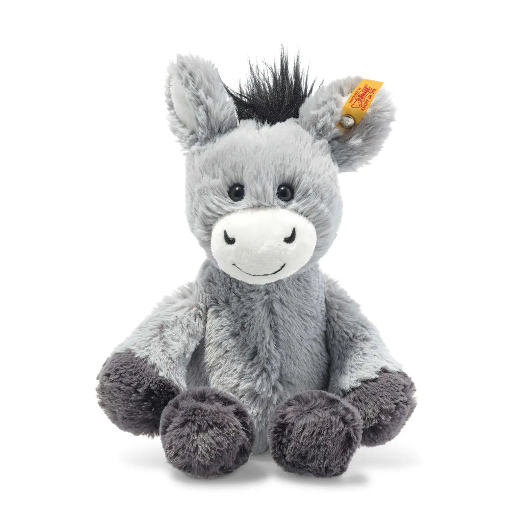 Presenting the Steiff Dinkie Donkey Plush Stuffed Toy: an 8-inch soft, gray donkey with darker gray hooves. Adorned with black hair on its head and a stitched, smiling face, it also features the iconic Button in Ear attached to a yellow and red tag. The background is plain white.