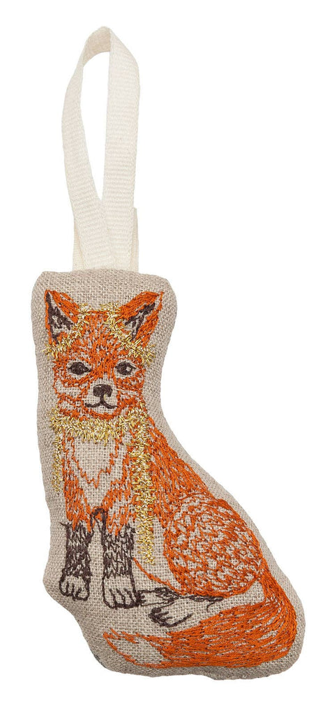 Introducing the Fox Tree Trimmer Ornament, a delightful decorative piece shaped like a sitting fox. It features vibrant orange embroidery and a convenient white hanger loop at the top. This charming ornament brings Christmas excitement to your home and adds to your cherished holiday memories.