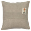 The Coral & Tusk Supermoon Spell Pillow is a square, beige pillow adorned with a small rectangular embroidered patch located in the top right corner. The patch showcases an orange coral design, a small image below it, and the text "CORAL & TUSK." The overall texture of this Halloween-themed pillow resembles linen.